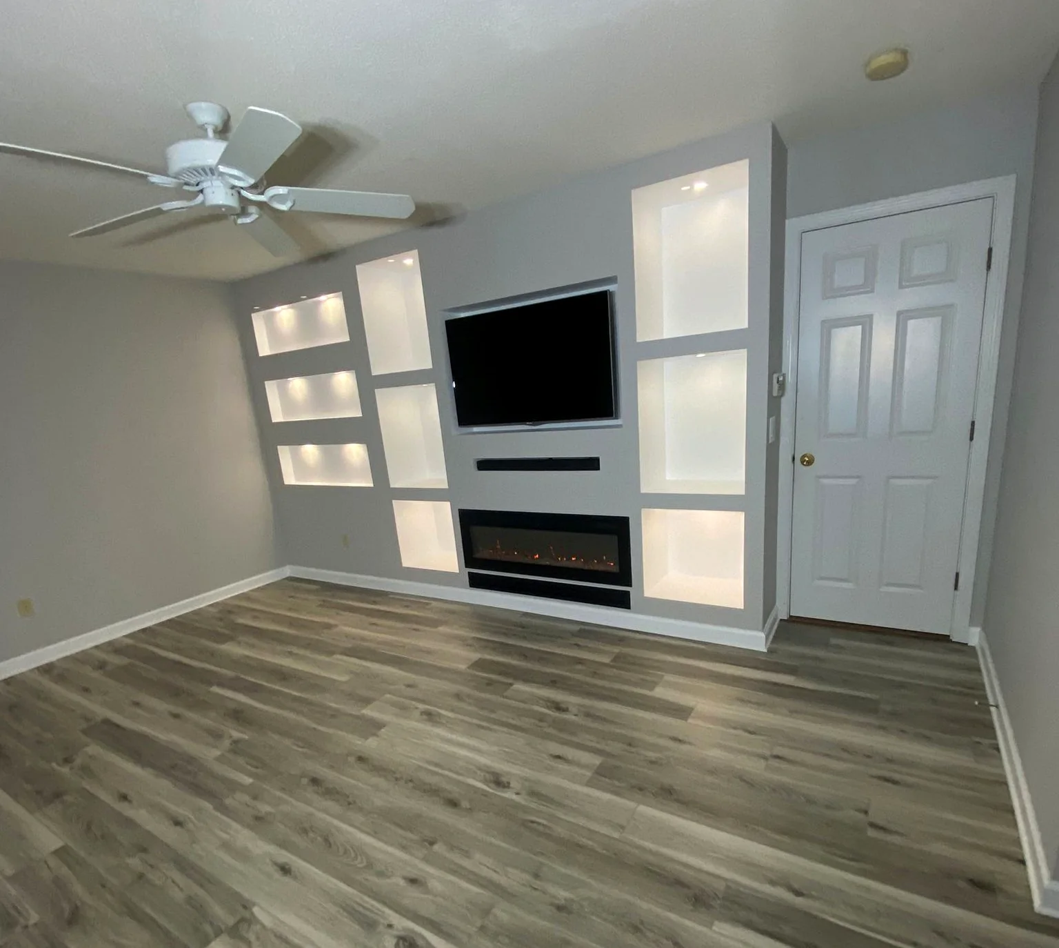 Finished living room feature wall with fireplace and flooring