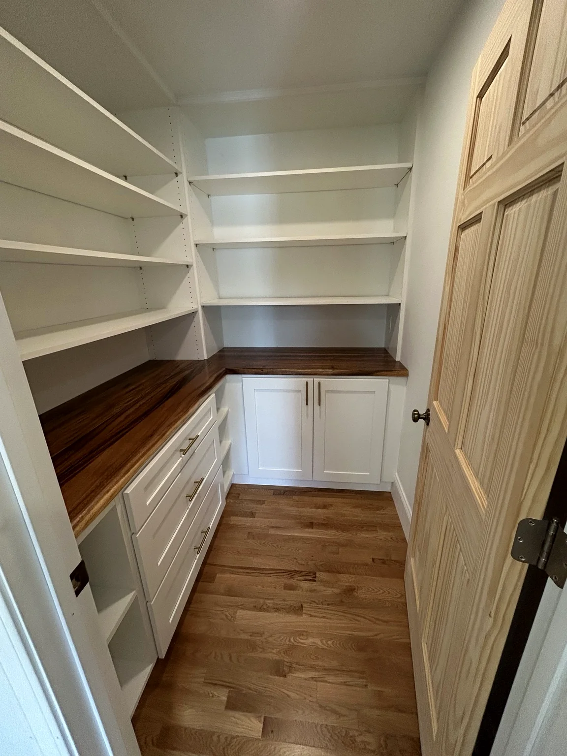 Custom pantry with shelves and wood countertops